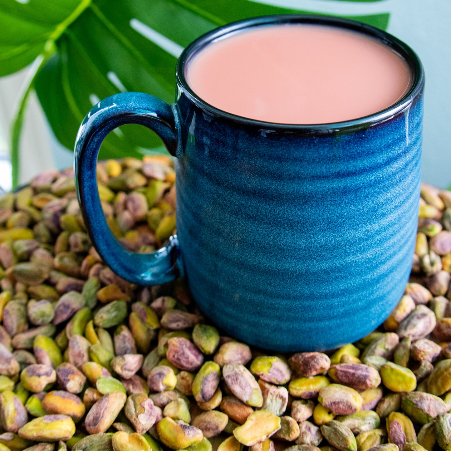 kashmiri chai spice infused coffee with pistachios in a blue mug